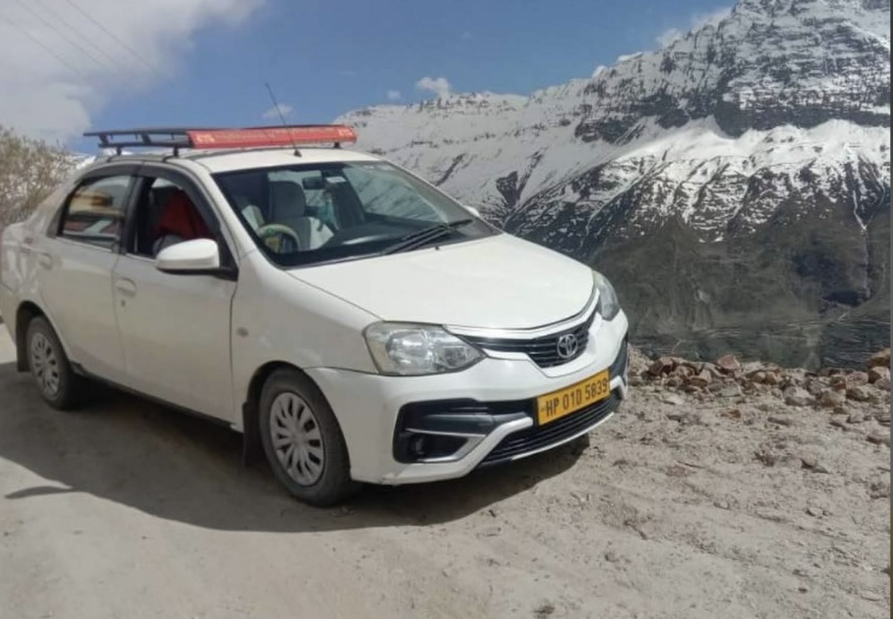 A Nandini Travels tour car on a Kangra valley road, Himachal Pradesh
